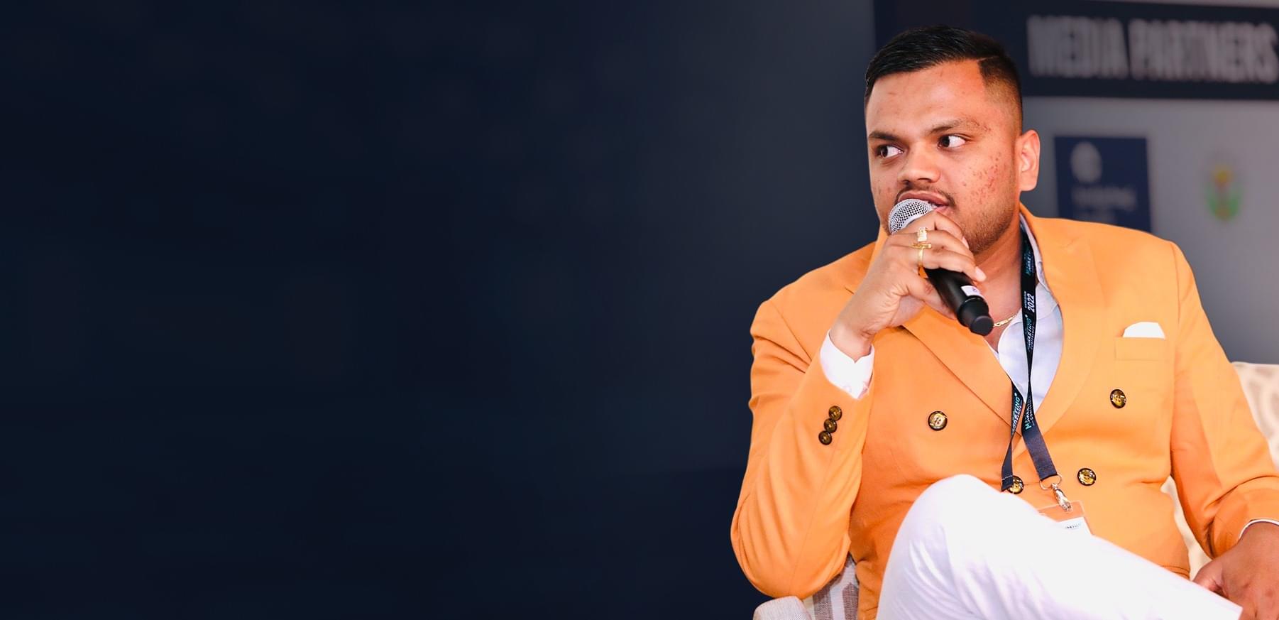 Ajay Rai speaking at a business event